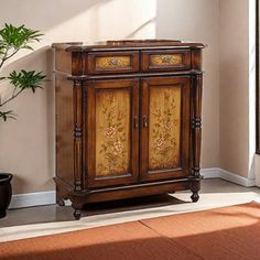 a wooden cabinet sitting in the corner of a room next to a potted plant