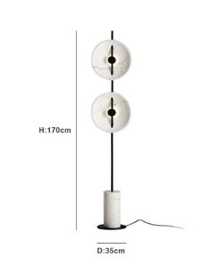 the floor lamp has three lights on it and is white with black trimmings