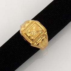 a gold ring sitting on top of a black belt