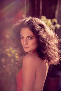 a woman in a red dress posing for a photo