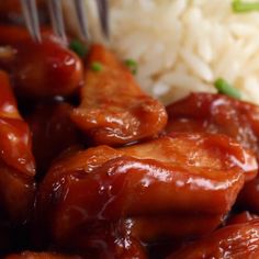 a close up of food on a plate with rice and a fork sticking out of it