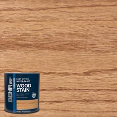 a can of wood stain sitting on top of a wooden floor