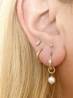 Now you can grab a set of our bestselling 14k Gold Filled Huggie Hoops and our gorgeous new dangles in one convenient set! Set includes one pair of gold huggies, one pair of freshwater pearl dangles, and one pair herkimer diamond dangles! Now you can switch out your earring style by simply sliding off one dangle and sliding on a new one! Or wear the huggies all on their own! It's 3 looks in 1! D E T A I L S 14k Gold Fill: hypoallergenic, anti-tarnish, nickel free SET INCLUDES: 1 pair gold filled Everyday Pearl Charm Huggie Jewelry, Everyday Huggie Jewelry With Pearl Charm, Everyday Hoop Earrings With Pearl Charm, Hypoallergenic Huggie Pearl Earrings, Everyday 14k Gold Hoop Earrings With Pearl Charm, Gold Huggie Earrings With Pearl Charm, Dainty Everyday Pearl Drop Huggie Earrings, Minimalist Pearl Charm Hoop Earrings For Everyday, Small Hoop Huggie Earrings With Pearl Drop