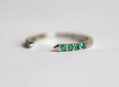 Dainty green emerald open band in 14k gold. Perfect as a wedding or stacking dainty pave ring or as a standalone knuckle gemstone ring. Details Gemstones: emeralds (or rubies, white diamonds, sapphires, black diamonds) Measurements: approx. 1.5 mm (8) Band width: approx. 1.8 mm Material: 14k solid yellow gold, white gold, rose gold Sizes available: 2-8 (Larger and smaller sizes are available as well. Priced upon request.) The design can be made with gemstones of your choosing. If you would prefe Emerald Wedding Rings, Emerald Ring Gold, Emerald Wedding, 18k Gold Ring, Pave Ring, Black Diamonds, Ring Women, Womens Wedding Bands, Emerald Ring