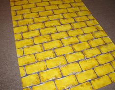 the floor is covered in yellow bricks and has been laid out on top of it