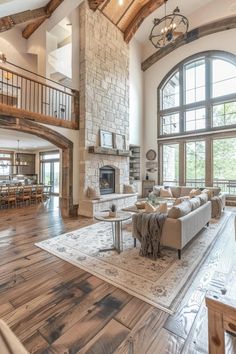 a large living room with high ceilings and wood flooring is pictured in this image