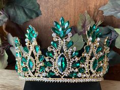 "Beautiful, sparkles, good quality Tiara with big Emerald Green stones, with Crystal Rhinestone set on gold Tiara. Perfect for Prom, Birthday, Sweet 16, Quinceanera, Anniversary, Wedding, or for any other special occasion. Or just to be THE QUEEN. THE COLORS ON THE TIARA: Gold tiara frame, Emerald Green and Crystal clear Rhinestone THE SIZE 3.5\" tall on the front. 2.5\" tall on the sides. GIFT BOX IT'S NOT INCLUDED! This item it will send on STANDARD FIRST CLASS MAIL (2 to 5 business days). in Emerald Green And Gold Jewelry, Quinceañera Crowns, Emerald Quinceanera, Quinceañera Decorations, Quince Jewelry, Quince Crown, Sweet 16 Tiara, Quinceanera Accessories, Birthday Sweet 16