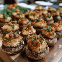 an assortment of stuffed mushrooms on a cutting board