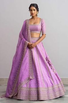 Lavender raw silk lehenga with cutdana worked temple border, striped pattern, floral motifs and cutwork hem. Comes with blouse and organza dupatta.
Components:3
Embroidered
Neckline:Square
Sleeve Length:Half
Fabric:Raw Silk; Dupatta: Organza
Color:Purple

Tie-up cutout back
Cutwork detail
Kamar tassels

 - Aza Fashions Purple Lehenga, Simple Lehenga, Raw Silk Lehenga, Anushree Reddy, Indian Outfits Lehenga, Wedding Lehenga Designs, Lehenga Designs Simple, Indian Bride Outfits, Traditional Indian Dress