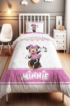 a bed with minnie mouse comforter and pillows