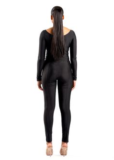 This set includes a long-sleeve, fitted top with a wrap-around detail, offering a flattering accent to the neckline and waist. The sleek, snug sleeves extend to partially cover the hands, adding a modern touch. The matching high-waisted leggings are designed to hug the body, featuring subtle vertical seams that enhance and elongate the legs. Polyester 95% Elastane 5% Model wears a size 'S' Winter Fitted Unitard, Minimal Stretch Long Sleeve Bodysuit For Fall, Long Sleeve Bodysuit With Minimal Stretch For Fall, Fitted Full Length Bodysuit For Winter, Sleek Long Sleeve Bodysuit With Minimal Stretch, Fitted Full-length Winter Bodysuit, Stretch Bodysuit With Back Zipper, High Stretch Long Sleeve Tops For Evening, Chic Long Sleeve Bodysuit With Minimal Stretch