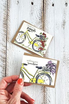 two handmade greeting cards, one with a bicycle and the other with flowers on it