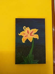 a painting of a flower on a yellow wall