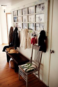 a wooden bench sitting next to a wall with pictures on it