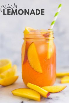 a mason jar filled with lemonade next to sliced lemons