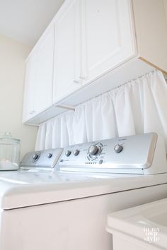 a white washer and dryer sitting next to each other in a laundry room