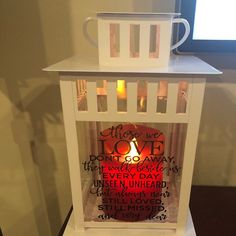 a candle that is sitting on top of a table with some words written in it