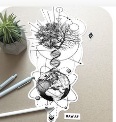 a sticker with a tree growing out of it on top of a table next to markers and pens