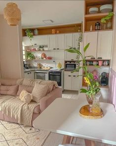 a living room filled with furniture next to a kitchen and dining area in a home