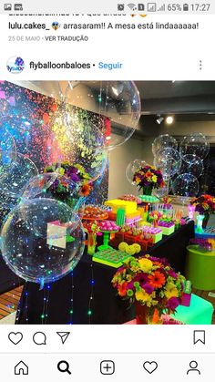 an image of balloons and flowers in the middle of a table with other decorations on it