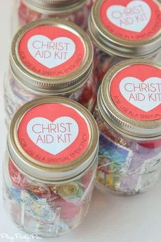 four jars filled with candy sitting on top of a table