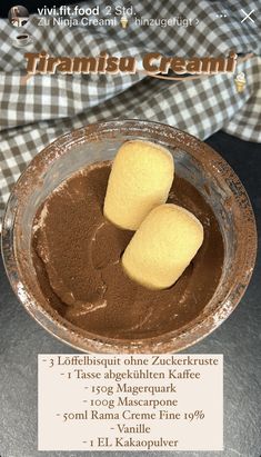 two pieces of cake sitting in a bowl on top of a table with a checkered cloth