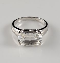 a white gold ring with an oval cut diamond