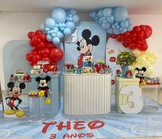 a mickey mouse themed birthday party with balloons