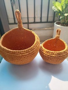 two woven baskets sitting on top of a table