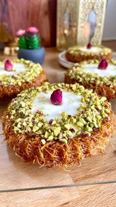 three desserts are sitting on a wooden table