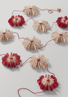 several red and white paper flowers on a string