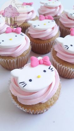 hello kitty cupcakes with pink frosting and bows on them are ready to be eaten