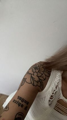 a woman with a flower tattoo on her arm