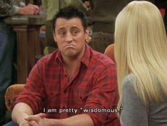 a man sitting at a table with a blonde hair in front of him and the caption says i am pretty, wisdommous