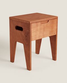 a small wooden stool with one drawer open