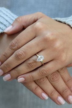 a woman's hand with a diamond ring on it