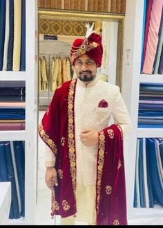 a man wearing a red and white outfit standing in front of a closet full of clothes