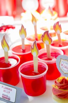 cupcakes with candles in them sitting on a table