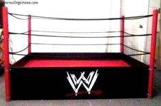 a red and black bed frame with the wwe logo on it