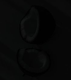 two pieces of fruit are shown in the dark