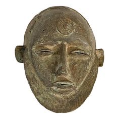 an ancient mask is shown against a white background