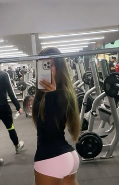 a woman taking a selfie in the gym