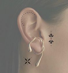 a woman's ear with black and white designs on the back of her ears