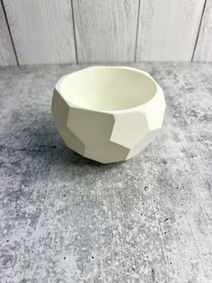 a white bowl sitting on top of a table