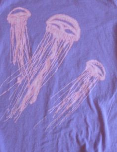 a purple shirt with jellyfish drawn on it