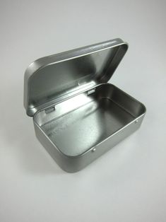 an empty metal container on a white surface