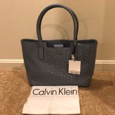 New! Calvin Klein Blue Perforated Double Handle Tote! Comes With A Dust Bag. Approximate Measurements: Length: 14" Depth: 4.25" Height: 10.25" Calvin Klein Tote Bag, Calvin Klein Fragrance, Color Block Tote Bag, Tan Tote Bag, Leather Fringe Bag, Tan Purse, Clear Tote Bags, Calvin Klein Bags, Calvin Klein Bag