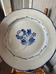 a blue and white bowl sitting on top of a wicker chair