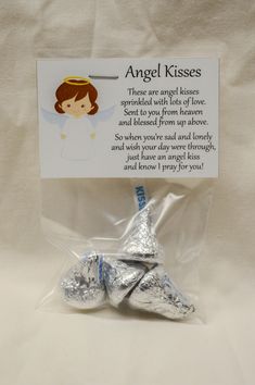 an angel kisses gift bag with two silver foiled candy hearts in the shape of angels