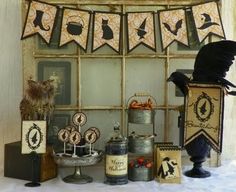 an assortment of items displayed in front of a window with halloween decorations on the windowsill